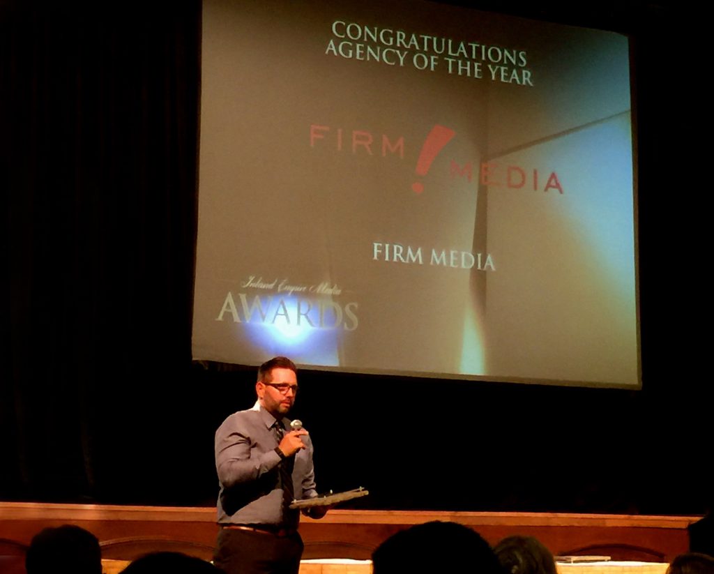 Image of Firm Media's CEO accepting the Agency of the Year award